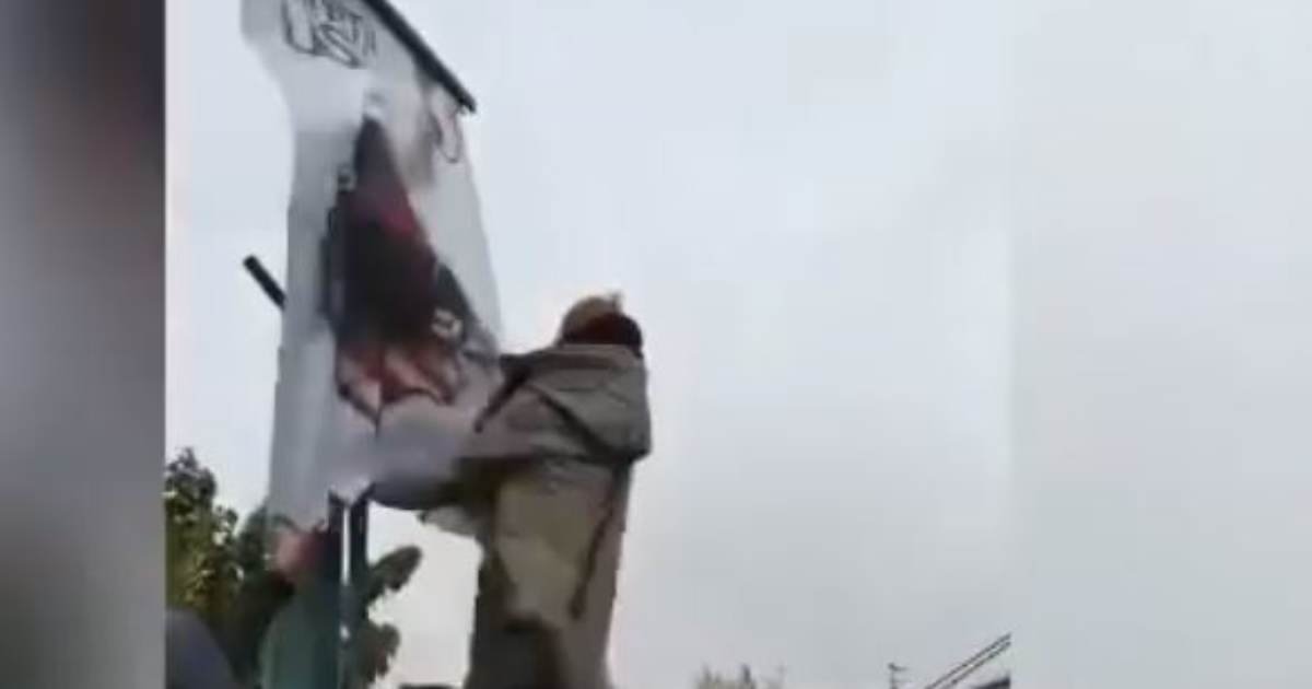 MUST SEE! Leaked Video from Iranian Protests Shows Brave Iranian Woman Climbing Lamp Post, Tearing Down "Death to America" Sign as MASSIVE CROWD CHEERS!