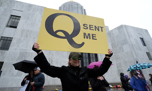 Facebook removes accounts linked to QAnon conspiracy... | Daily Mail Online