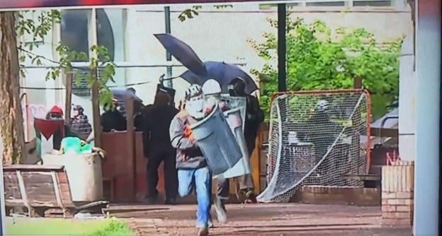 Pro-Hamas Agitator Using Garbage Can as Shield Charges Awkwardly at Police and Gets a Rude Awakening During Protest at Portland State University (VIDEO) | The Gateway Pundit | by Cullen Linebarger
